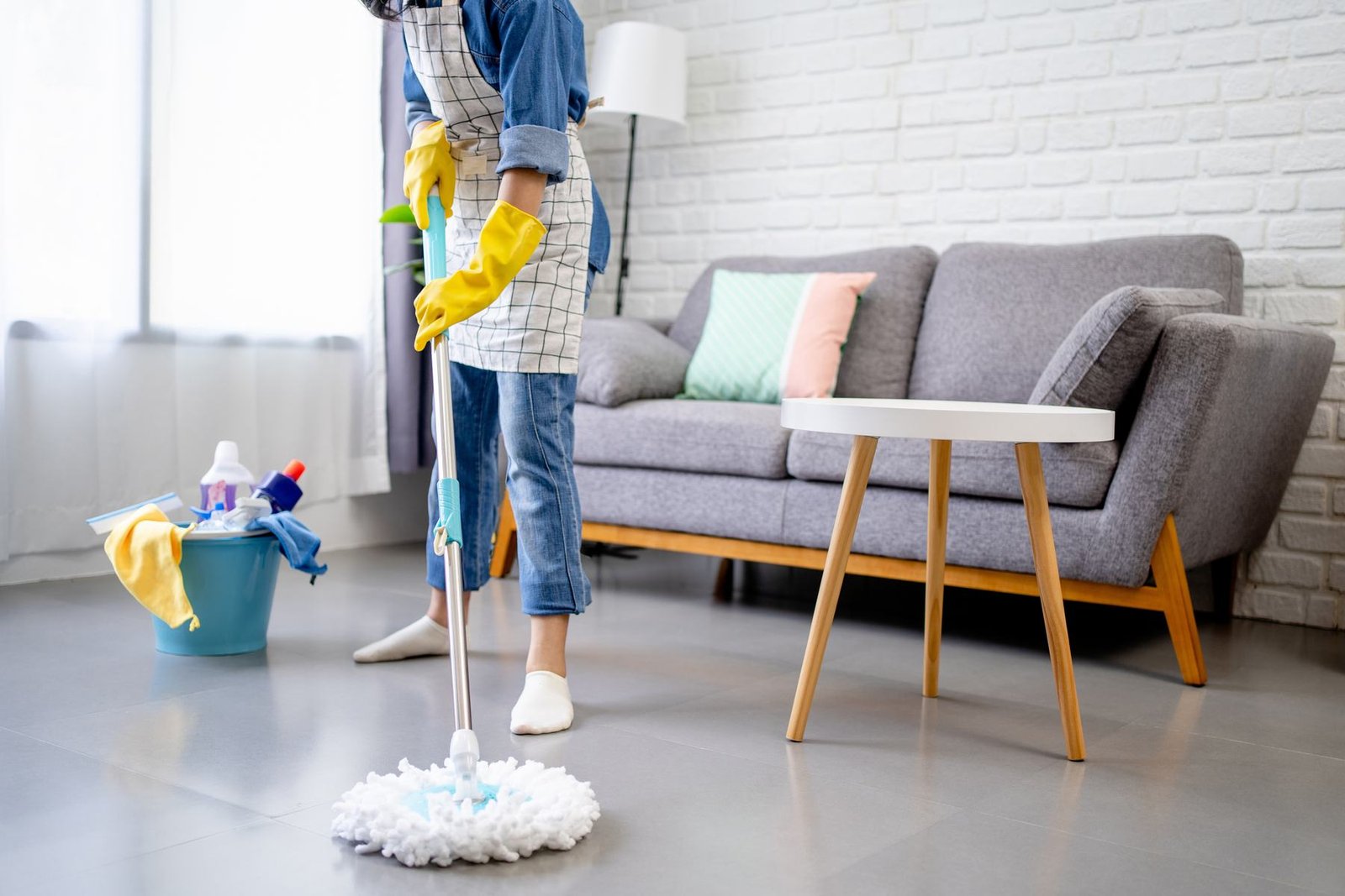A cleaning professional working in a client's living room